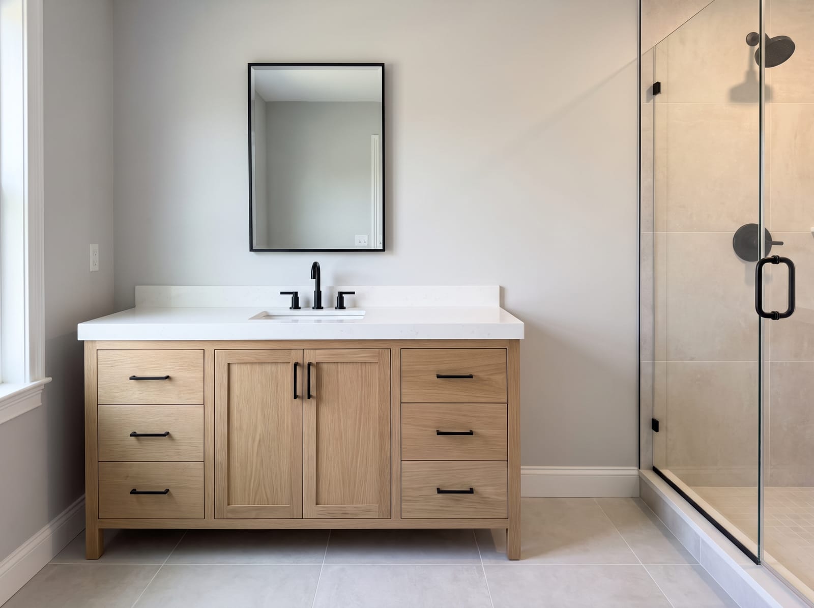 A fully remodelled bathroom with tiled walls and a glass enclosure